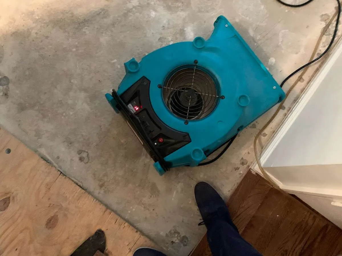 Air mover drying subfloor during Commercial Water Damage Restoration in Maple Heights